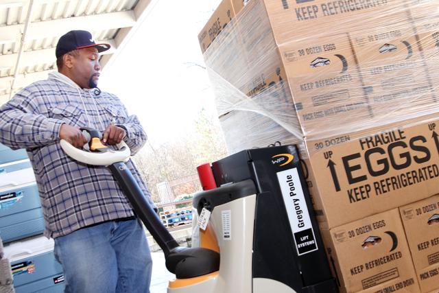 Warehouse assistant Joseph Haywood unloads a crate of eggs from an Inter-Faith Food Shuttle truck on Friday January 13, 2012 at the IFFS warehouse. Inter-Faith Food Shuttle relies on food donations to distribute to people in the community that are in need of food. Photo by Tyler Andrews