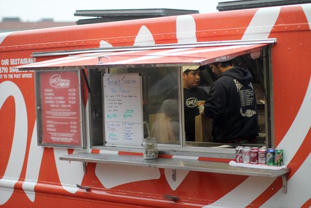 Only Burger food truck turns out juicy burgers and hot fries to Centinnial Campus customers on Wed., Jan. 11. The three employees in the truck hustle to get the large orders of food out in a short amount of time. Only Burger has been sending a truck out to Centennial Campus for the past year, and has been on the road for the past eight. Photo by Vanessa Movasseghi