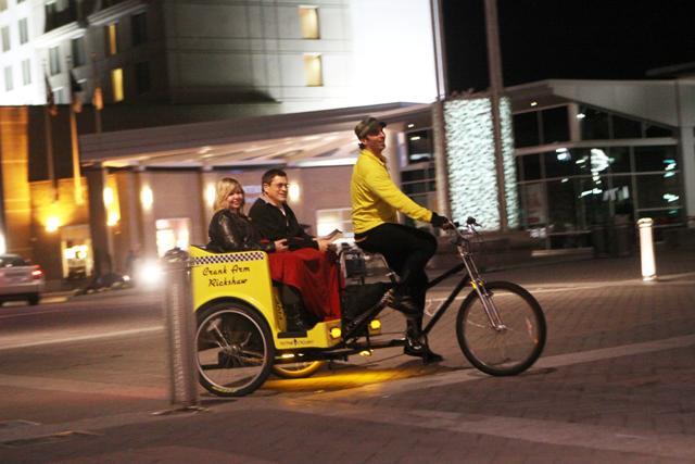 Biking around Raleigh with some customers, Rickshaw driver Chris Daugherty, 2008 graduate, show them the city. "I like to roll around and say 'hi' to everyone," Daugherty said.