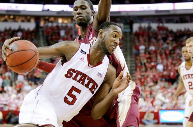 Sophomore forward C.J. Leslie drives around a Florida State defender during the basketball game in the RBC Center Saturday, Feb. 18. The Seminoles defeated the Wolfpack 76-62. Photo by John Joyner.