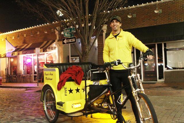 Rickshaw driver Chris Daugherty, 2008 N.C. State alum, describes how he got into the chauffeuring business last year. "It's like becoming a mason. You have to know one to be one." Photo by Natalie Claunch
