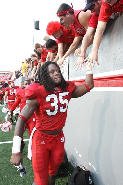 Redshirt sophomore linebacker Terrell Manning slaps the hands of fans after homecoming game against Wake Forest Nov. 13, 2010. N.C. State dominated Wake Forest, 38-3. Photo by Luis Zapata.