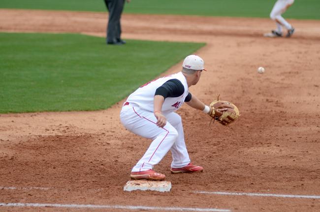 Catching the ball at first, senior Andrew Ciencin tags a Wake Forest runner out during the third inning Sunday. Photo by Ryan Parry.
