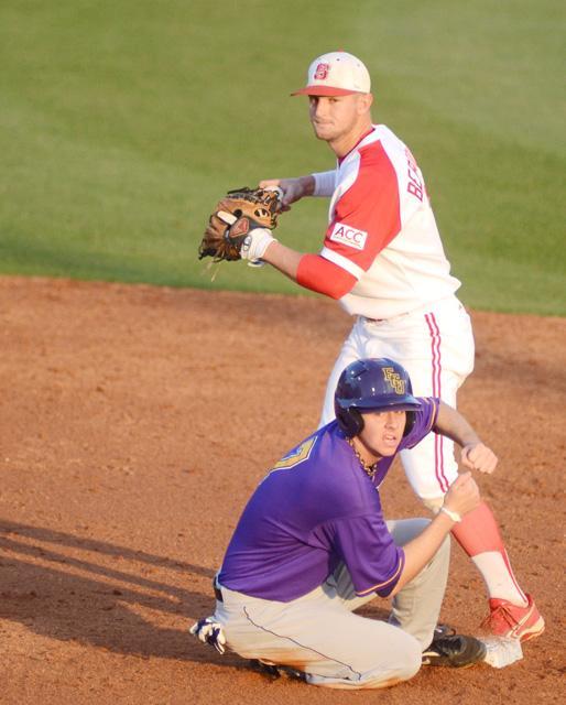 After tagging a runner out at second, junior Matt Bergquist looks to first base. The Wolfpack took on the East Carolina Pirates Wednesday, March 28 at Doak Field at Dail Park. Photo by Ryan Parry.