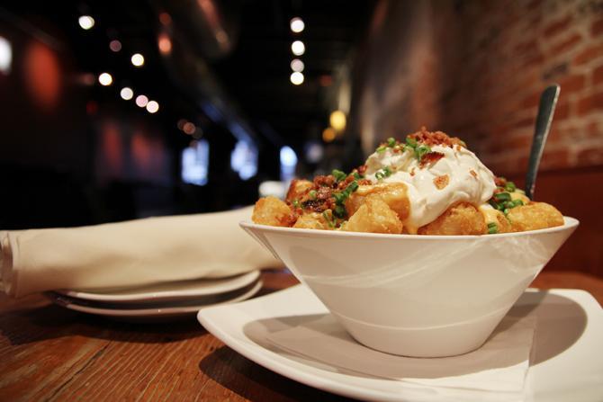 One of Busy Bee Cafe's best selling dishes, the Loaded Tots are made of tater tots, cheddar, bacon, sour cream and scallion. Photo by Tyler Andrews