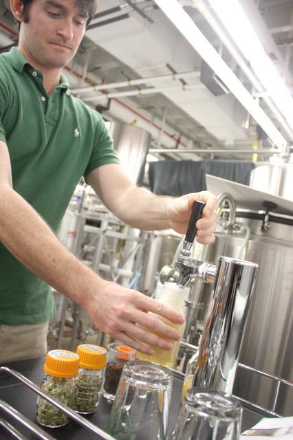 Blake Layfield, a graduate student researching fermentation, fills a glass with a sample of a pilsner brew from their most recent batch. "Beer is a really great tool for getting food science out to the general public," Layfield said.