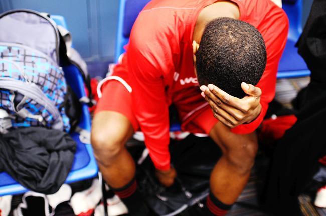 Junior guard Patrick Johnson hides his face in the locker room following the Wolfpack&#8217;s loss to the Kansas Jayhawks, 60-57, in the Sweet Sixteen round of the NCAA Tournament on Friday in St. Louis, Mo. Photo by Jordan Moore.