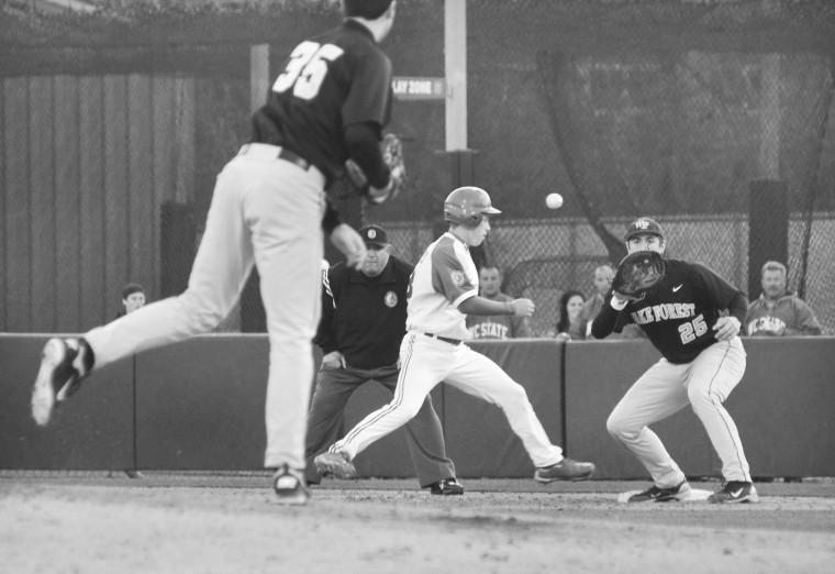 Junior outfielder Brett Williams leaps back to first as Wake Forest pitcher Tim Cooney makes a pick off attempt in the game April 2, 2011. Williams was safe and N.C. State won the game, 4-2. Archived photo by Alex Sanchez