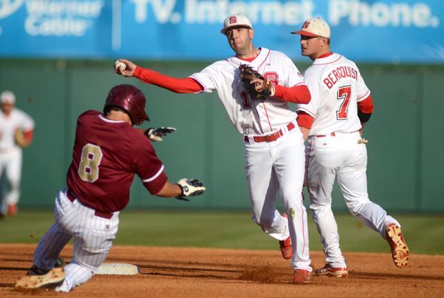 Making a double play, junior Chris Diaz throws the ball to first base after tagging an Elon runner out at second. Diaz went 1-for-4 and had 2 RBI's in the Wolfpack's 14-2 win over Elon Wednesday, April 11. Photo by Ryan Parry.