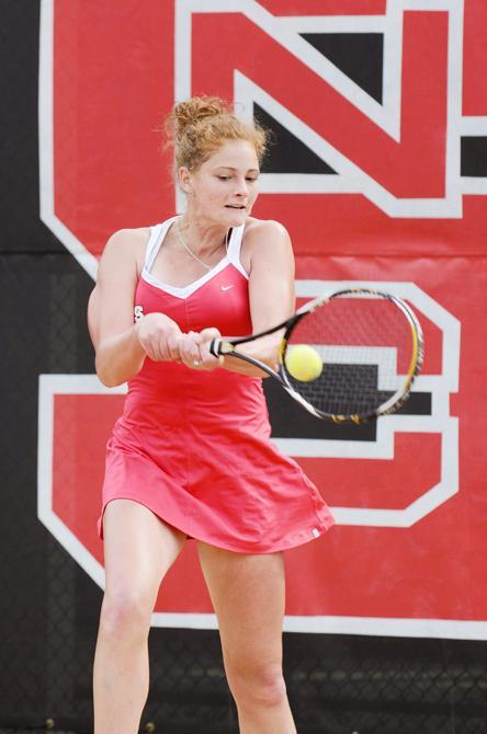 Senior Ashley Miller returns a volley during her singles match against Virginia Tech at the Curtis and Jacqueline Dail Outdoor Tennis Stadium Sunday, April 1, 2012. The Wolfpack defeated the Hokies 4-3. Photo by John Joyner.