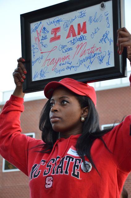 Carizma Thomas, junior in communication, holds a whiteboard in protest of the Trayvaon Martin case. Photo by Charlie Harless