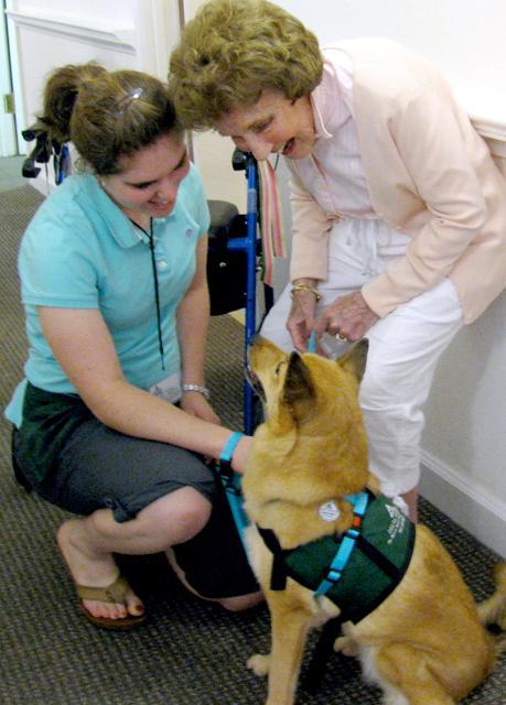 Mary Pat Bulfin, left, is the founder of the dog therapy club, Pawssibilities. Photo courtesy of the club.