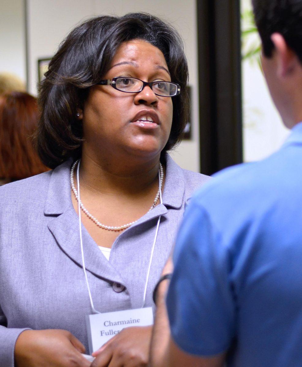 Charmaine Cooper speaks to a Wake County citizen before the public hearing Tuesday. Cooper has a Masters of Public Administration from NCSU. The 2007 alum is Executive Director of the N.C. Justice for Sterilization Victims Foundation.