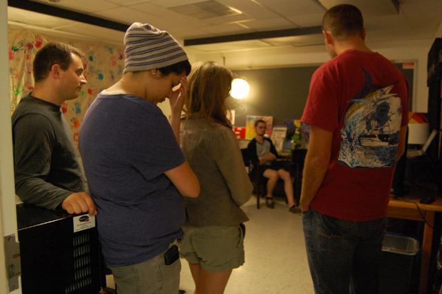 Matt Woodward, Caitlin Cohn, and other students gather in the GLBT Center to listen to the results of the North Carolina Primary elections on Tuesday night. Amendment One, a constitutional amendment that defines marriage between one man and one woman the only legal union considered valid by the state, passed with a 61-39 majority. Photo by Megan Farrell