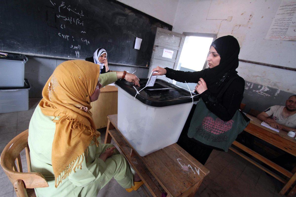 Egyptian women practice their right to vote.