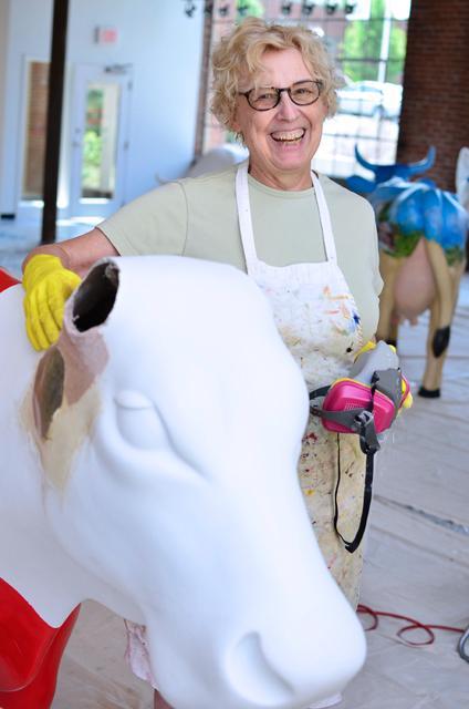Mary Lamb, a Chapel Hill-based artist, stands beside a work in progress piece for the triangle Cow Parade. Golden Belt studios, in downtown Durham, has provided local artists with open studio space to complete their cow projects. Lamb will complete two Raleigh themed cows; one titled "Sir Walter COWleigh," and the other "North COWalina State Wuf," which is pictured here.