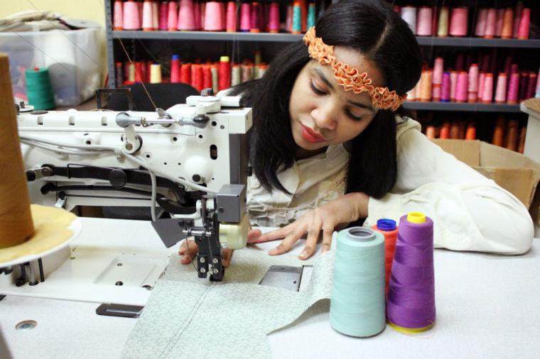 Jazsalyn McNeil, junior in fashion and textile management works on one of her designs for the Charleston Fashion Week.&#160;