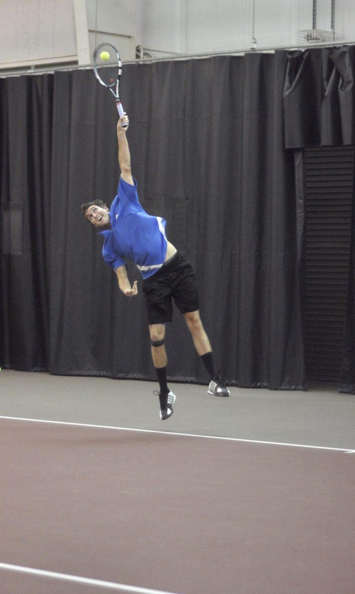 Junior Sean Weber serves the ball during the doubles final of the Atlantic Tire and Service Triangle Tennis Challenge Nov. 19 2012 in the Isenhour Tennis Center. The Challenge was a charity tournament with the proceeds benefiting ovarian cancer awareness. Photo by Chris Rupert