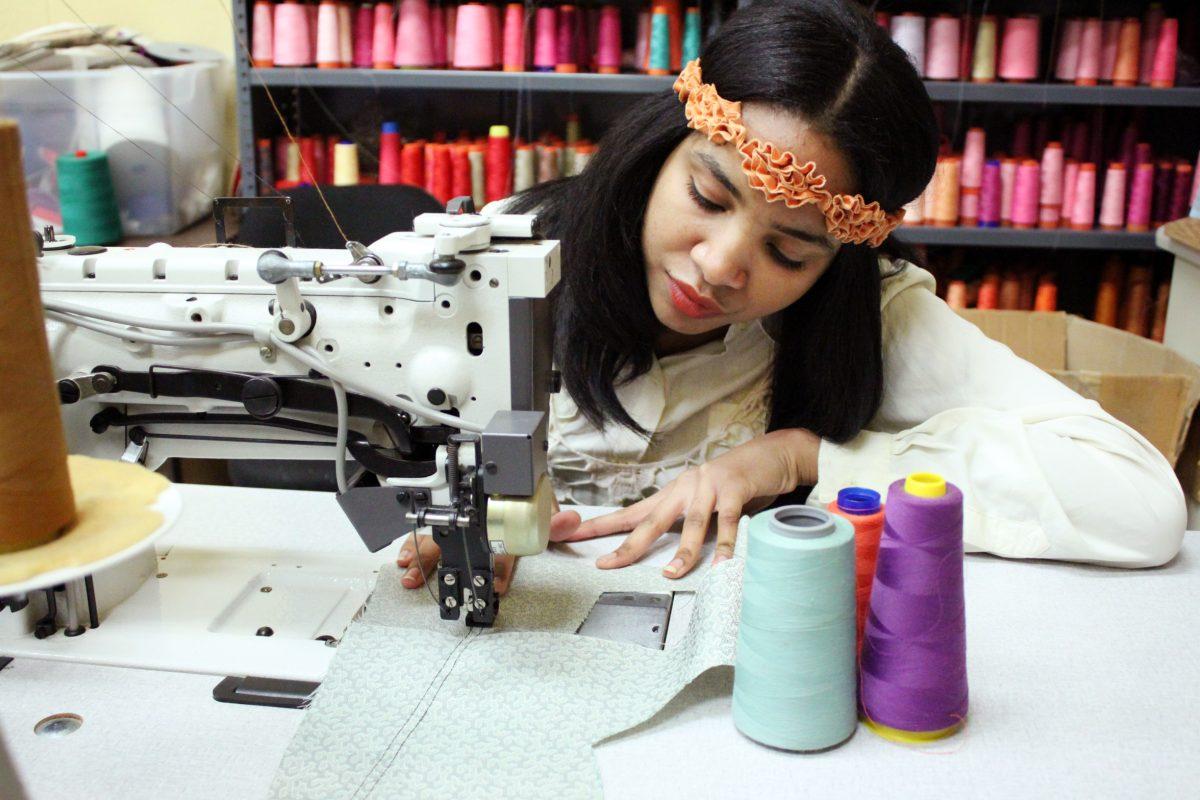 Jazsalyn McNeil, junior in fashion and textile management works on one of her designs for the Charleston Fashion Week.&#160;