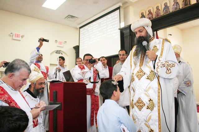 Anba David, the General Bishop of the Archdiocese of North America offers his blessing to a child during Mass on Christmas Eve.