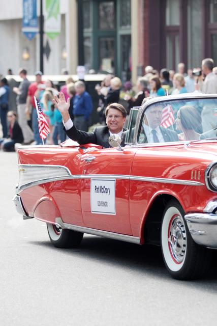 Photo by Joannah Irvin. Governor Pat McCrory waves during the inauguration parade in downtown Raleigh on January 12.