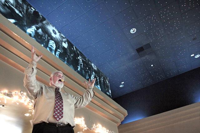 An auctioneer calls for bids on the fiber-optic ceiling in the lobby of Galaxy Cinema . The ceiling which lights up to display constallations and occasional shooting stars sold for a mere $30. Galaxy Cinema, a theatre in Cary which closed its doors Nov. 2012, was auctioned off piece by piece Saturday Jan. 13, 2013.&#160;
