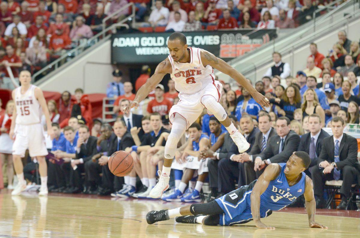Junior guard Lorenzo Brown jumps over Duke junior guard Tyler Thornton in an attempt to steal the ball during the basketball game against Duke in PNC Arena Saturday, Jan. 12, 2013. The No. 20 Wolfpack defeated the No. 1 Blue Devils 84-76.