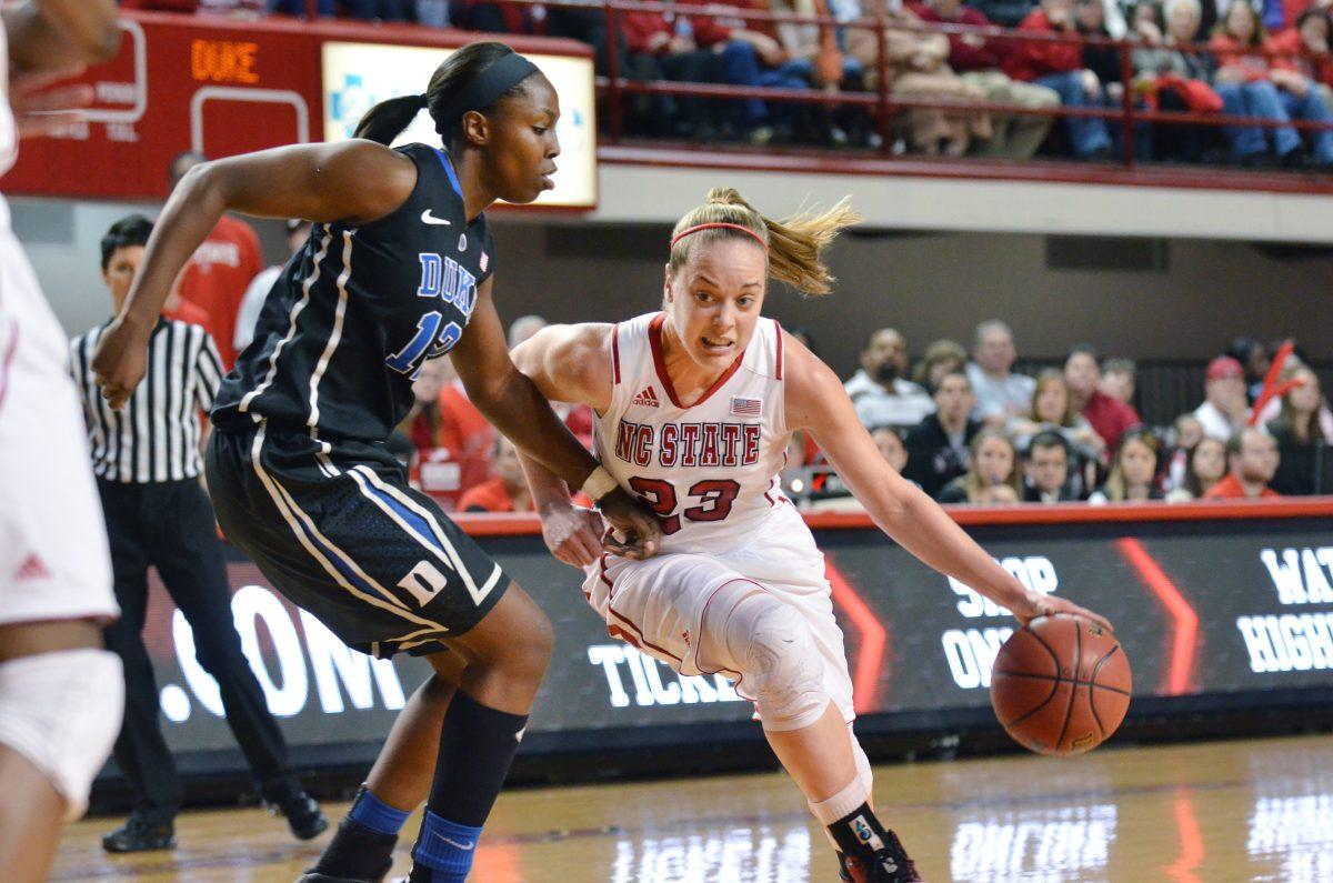 Senior guard Marissa Kastanek drives around Duke junior guard Chelsea Gray during the basketball game in Reynolds Coliseum Thursday, Jan. 3, 2013. Photo by John Joyner.