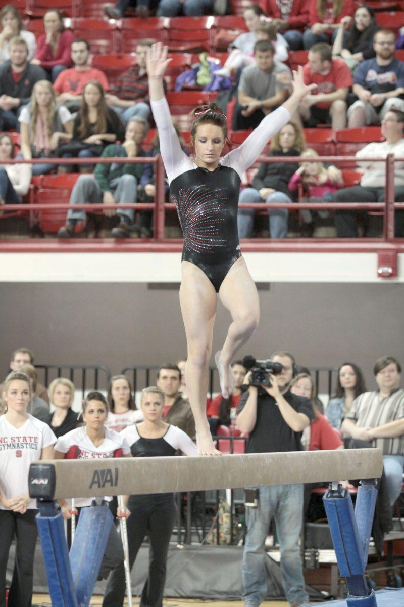 Photo by Joannah Irvin. Junior gymnast Heidi Ffield competes on the beam against Maryland on January 11. The Wolfpack tied with the Terrapins with a score of 159.000. The Wolfpack's next home meet will occur on January 25 against West Virginia.