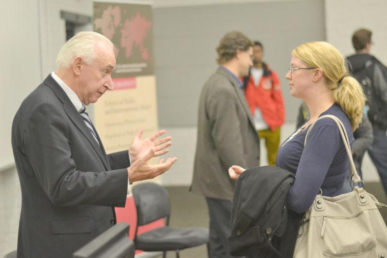 Jim McLay, New Zealand's Ambassador to the United Nations, converses with Sarah Cowles, Program Coordinator in the Office of International Affairs, in Parks Shops Tuesday, Jan.15. McLay gave a presentation to students and faculty about the origins and development of the International Criminal Court and its impact on the United States. Photo by Caide Wooten.