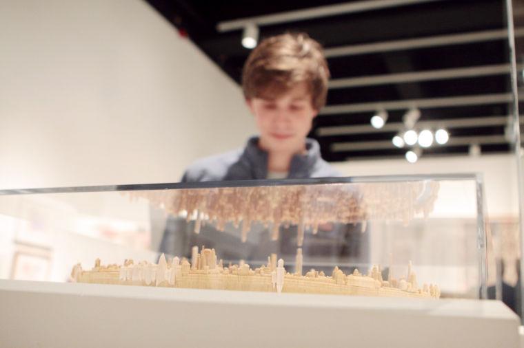 Graham Dean, a sophomore in political science, examines an art piece at the Gregg Museum opening of the Mad Science, Fringe Architecture and Visionary Engineering collection on Jan. 17. "I came because I am on the board and I wanted to see the collection," Dean said. The collection will be on display in Talley Student Center until May.