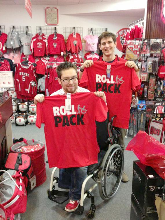 Will Privette and Student Body President, Andy Walsh, hold up the new &#8220;Roll Pack&#8221; shirts.