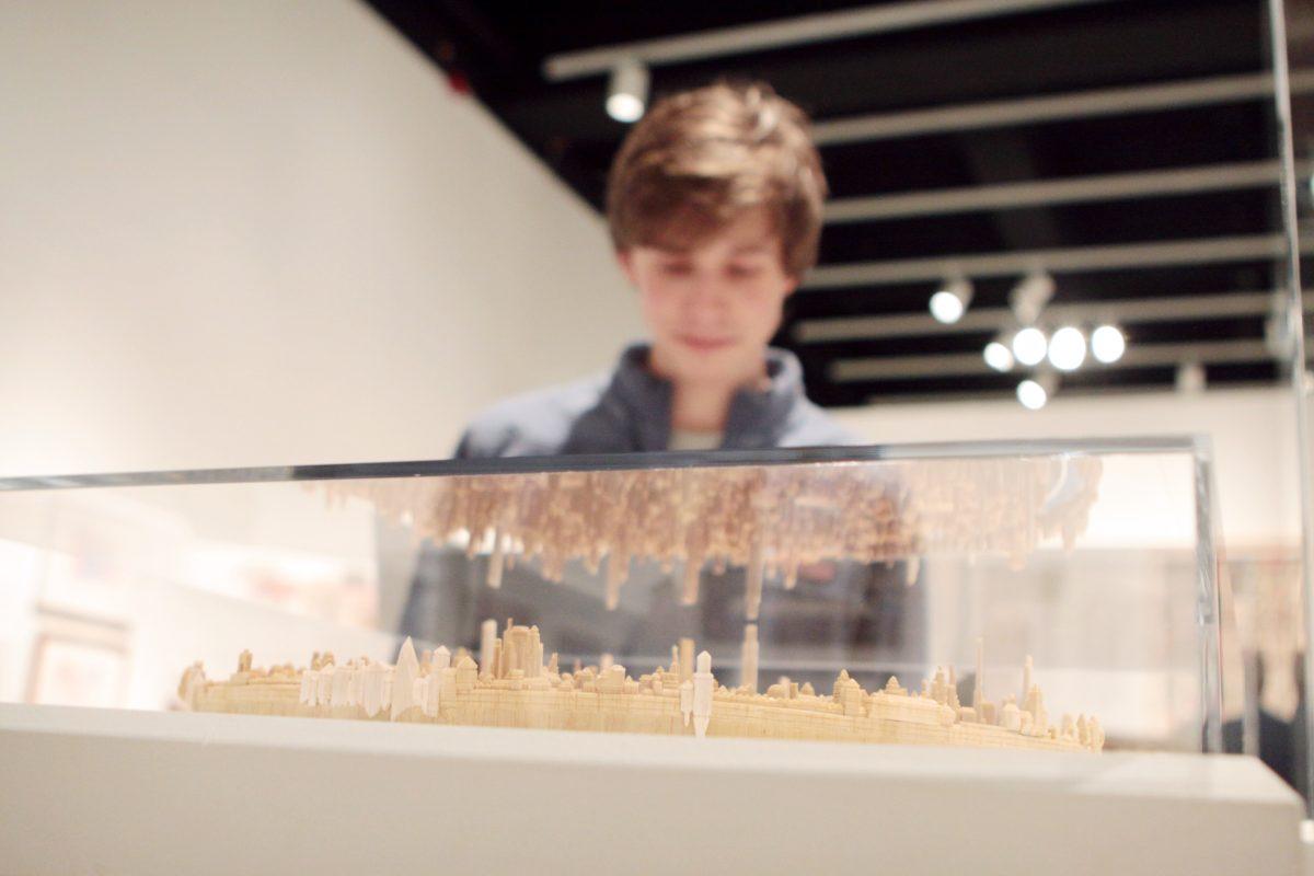 Graham Dean, a sophomore in political science, examines an art piece at the Gregg Museum opening of the Mad Science, Fringe Architecture and Visionary Engineering collection on Jan. 17. "I came because I am on the board and I wanted to see the collection," Dean said. The collection will be on display in Talley Student Center until May.