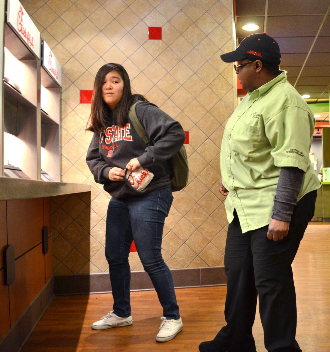 With a student volunteer and an Atrium employee, this photo models the problem of food theft in the Atrium.