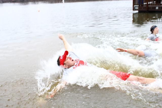 A member of Campus Recreation spashes into Lake Raleigh for the N.C. State Polar Plunge on Saturday February 23, 2013. Partipants of the event raised money for the Special Olympics. Photo by Katherine Hoke