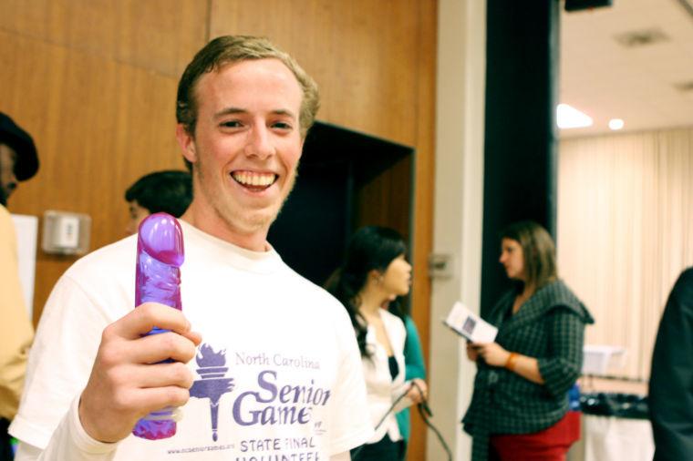 Brian Branch, sophmore in sports management, models a purple dildo during the Sexual Communications Fair in Talley Student Center in November.