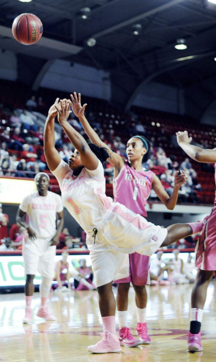 Junior guard Myisha Goodwin-Coleman shoots the ball Feb. 21 at Reynolds Coliseum against Miami. After briefly leading in the second half, the Wolfpack fell to the Hurricanes 59-55. Photo by Chris Rupert
