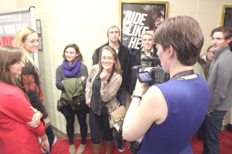The first students in line on the red carpet are interviewed by CMF while waiting for the Saturday night premiere.