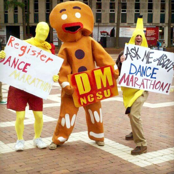 NCSU Dance Marathon committee members, Alana Propst, Arturo Corrales and Ryan Taylor, work the NCSU Dance Marathon&#8217;s&#160; sign-up booth in the Brickyard.