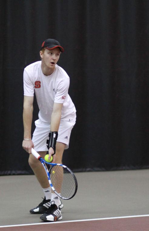 Photo by Joannah Irvin. Freshman tennis player, Simon Norenius, prepares to serve during the N.C. State opening home match against Northwestern University on Friday Feb. 1 2013. The Wolfpack fell to the Wildcats with a score of 4-3. The Pack's next home meet will occur on Feb. 19 against Middle Tennessee State.