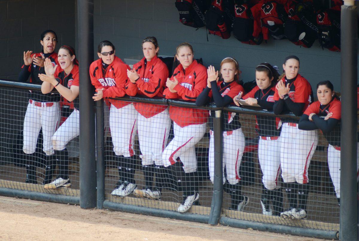 Sitting in the dugout, the Wolfpack softball team cheer on their batters on the field. N.C. State won 4-2 against Toledo Sunday, February 26, 2012 in their final game of the Wolfpack Classic. Photo by Ryan Parry.