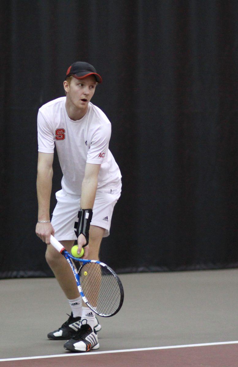 Photo by Joannah Irvin. Freshman tennis player, Simon Norenius, prepares to serve during the N.C. State opening home match against Northwestern University on Friday Feb. 1 2013. The Wolfpack fell to the Wildcats with a score of 4-3. The Pack's next home meet will occur on Feb. 19 against Middle Tennessee State.