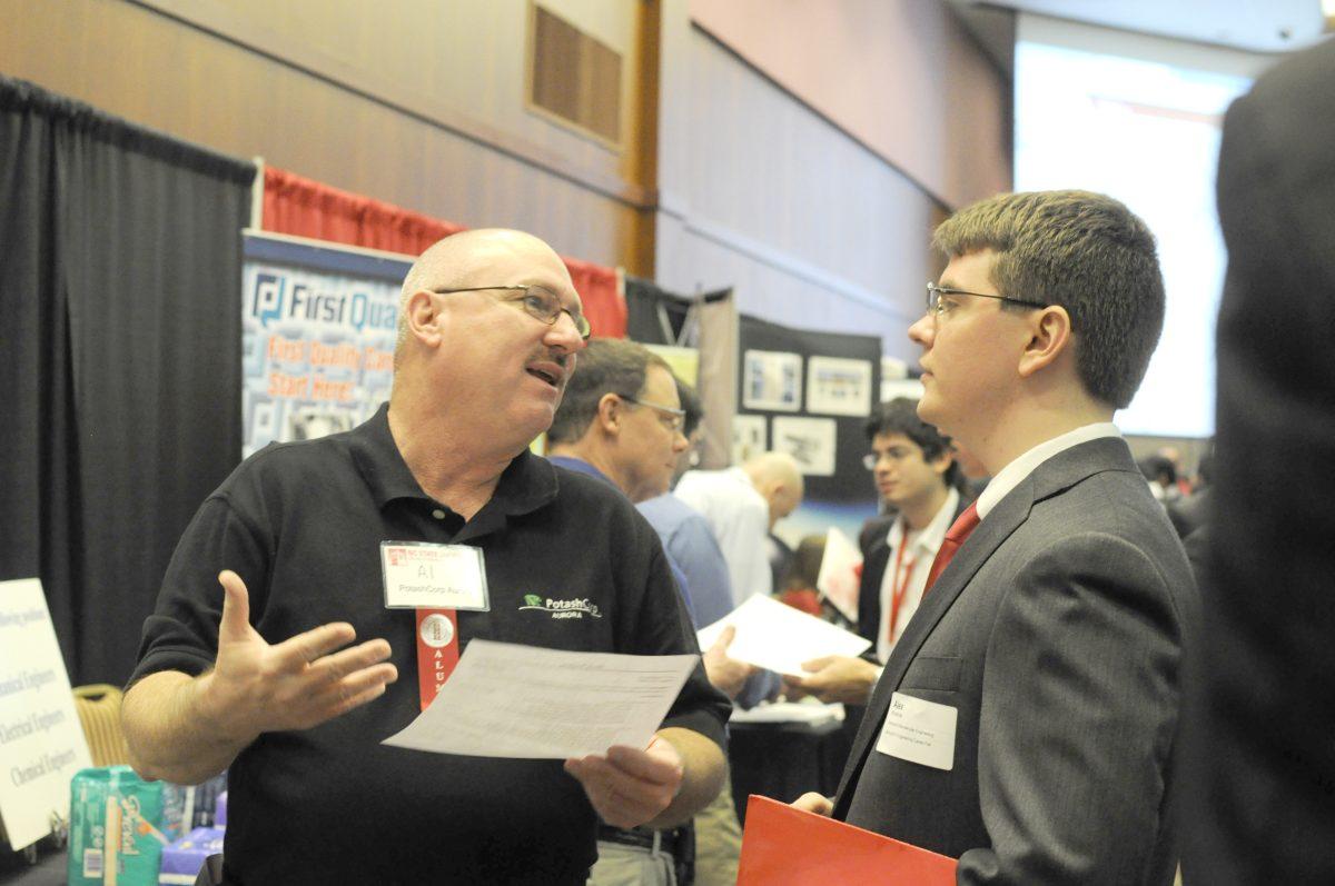 Alex Woodrow, a senior in chemical engineering speaks to Al, a representative from PotashCorp Aurora Wednesday Feb. 6, 2013 at the Engineering Career Fair at the McKimmon Center. The fair attracted an estimated 2000-3000 students and over 200 recruiters. Photo by Chris Rupert