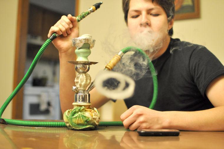 Gabriel Hoskins, a junior in civil engineering, makes smoke rings with his hookah. "Making smoke is most of the fun," Hoskins said, "and it is pretty relaxing." Hoskins said it gives him something to do while chilling with friends, "It's really an excuse to hang out."