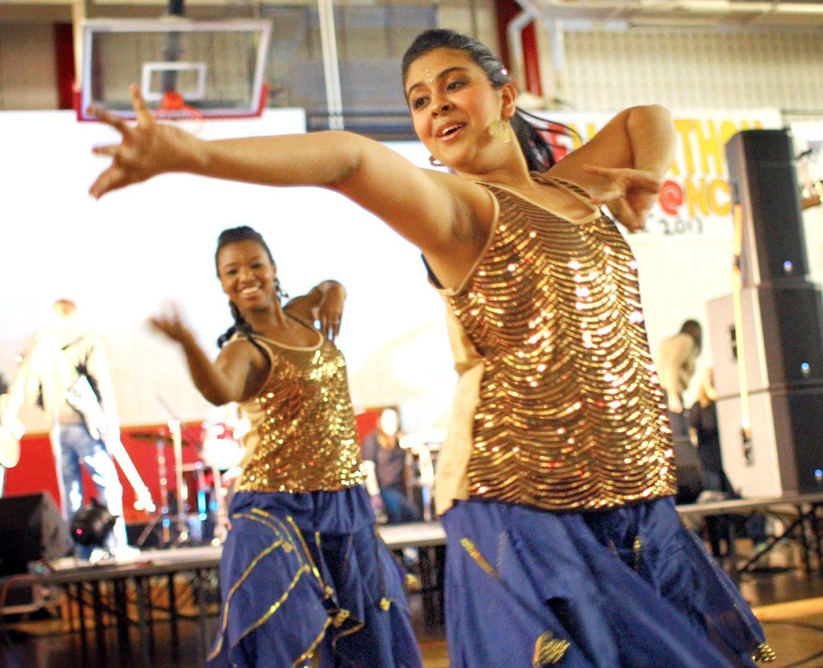 Senior in Zoology Xialansha Ruiss and Senior in Biochemistry Raveena Chhabria perform with Nazarre at the Dance Marathon Feb. 22. The event raised money for the Children's Miracle Network Hospitals. Photo by Katherine Hoke