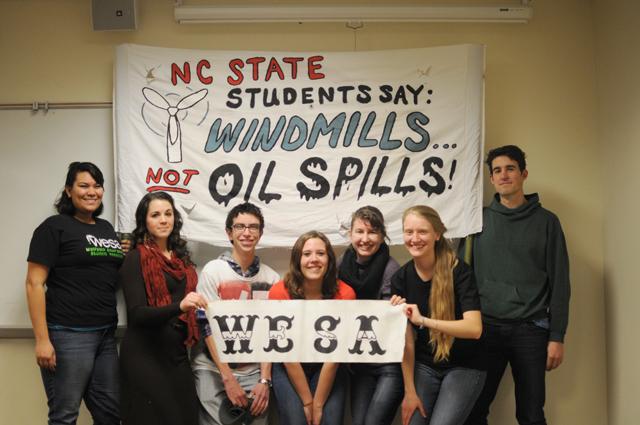 (From left to right) Lee howe, Heather Troutman, Jason Hull, Tanya Godsey, Hannah Gotsch, Jaclyn Mills, Will Hildreth, officers of the Wolfpack Environmental Student Association hold a sign from a protest they went to in Washington, D.C., on Feb. 17, 2013. "We protested the contruction of the Keystole XL Pipeline with 30,000 other people," co-president Godsey said. Photo by: Sam O'Brien