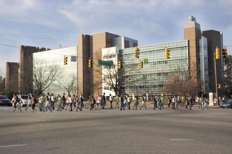 This photo-illustration portrays students crossing a busy intersection on the corner of Western Boulevard and Avent Ferry Road.