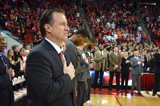 Men's basketball head coach Mark Gottfried holds his hand over his heart during the national anthem before the men's basketball game in PNC Arena Sunday, Jan. 20, 2013. The Wolfpack defeated the Tigers 66-62. Photo by John Joyner.