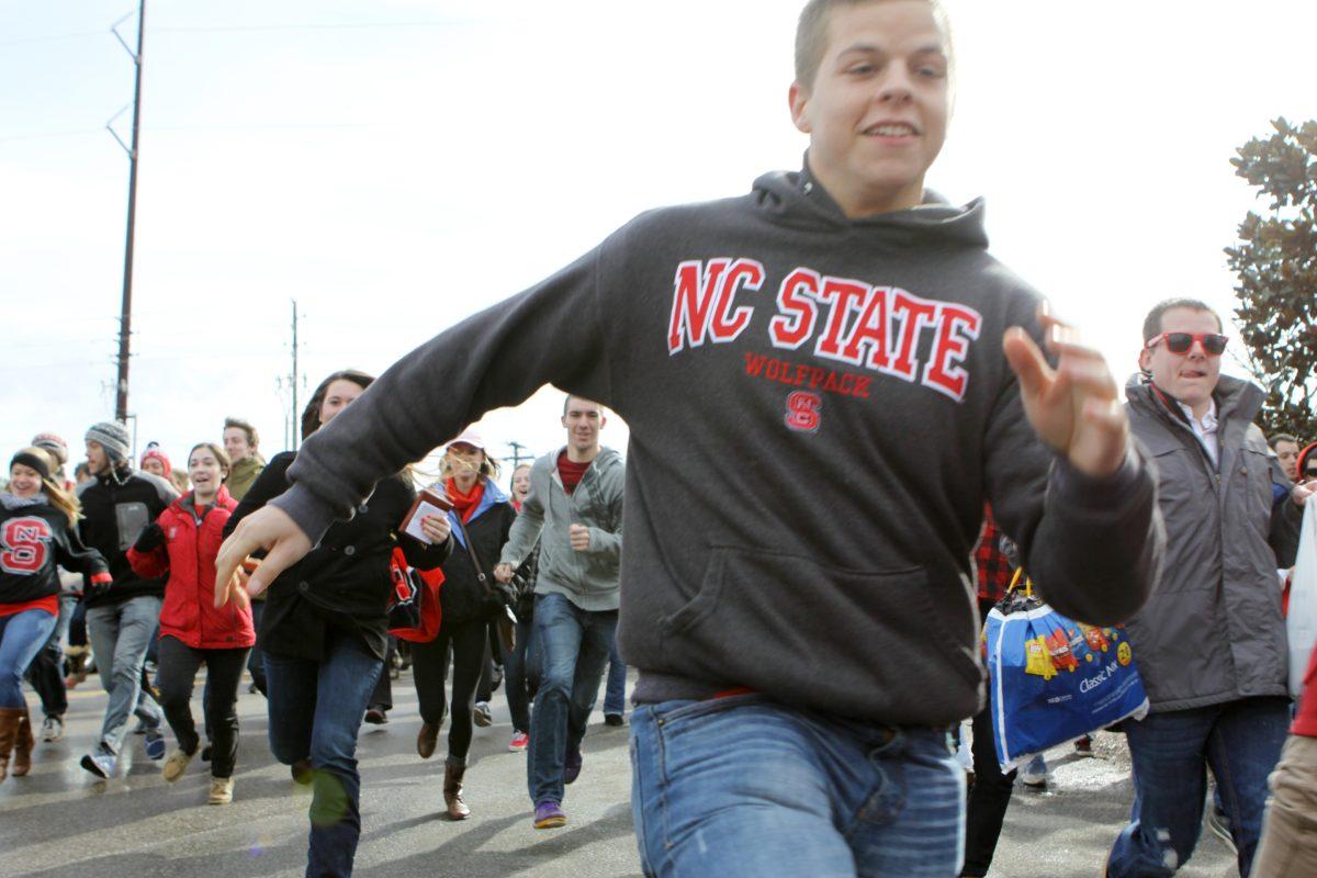 N.C. State students sprinting across the Carter-Finley/PNC Arena property in attempt to be the first people in line for the UNC Chapel Hill game.