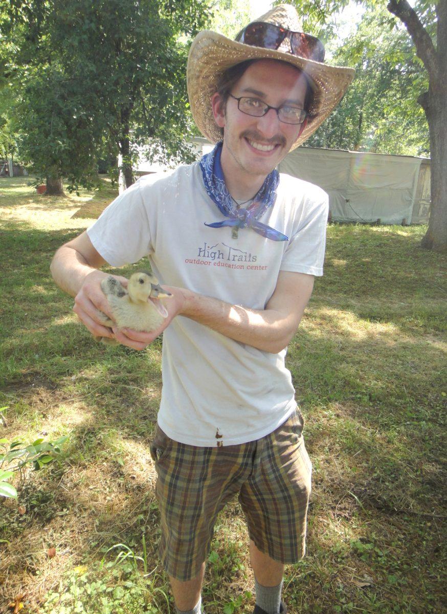 N.C. State alumnus Eric Bowen holds a duck at a farmers&#8217; market. Bowen, a graduate of the College of Natural Resources started a virtual farmers&#8217; market to help farmers save profits and eliminate waste.